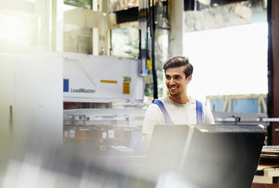 Smiling male on a production site
